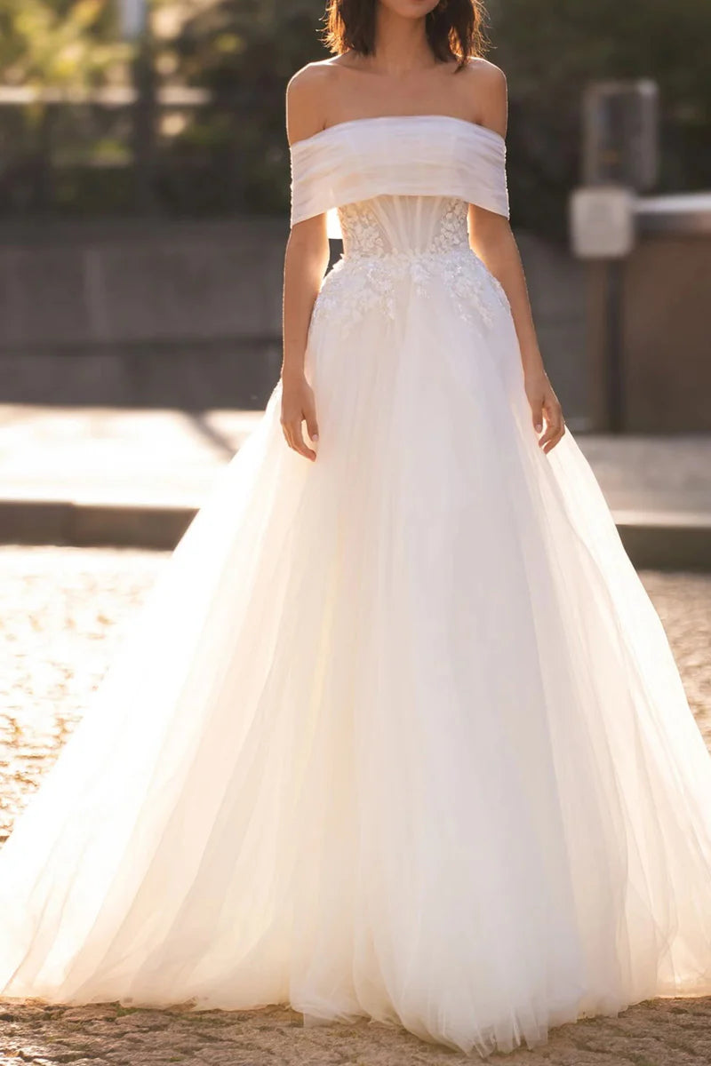 A-Line strapless wedding dress with lace appliques, front view.