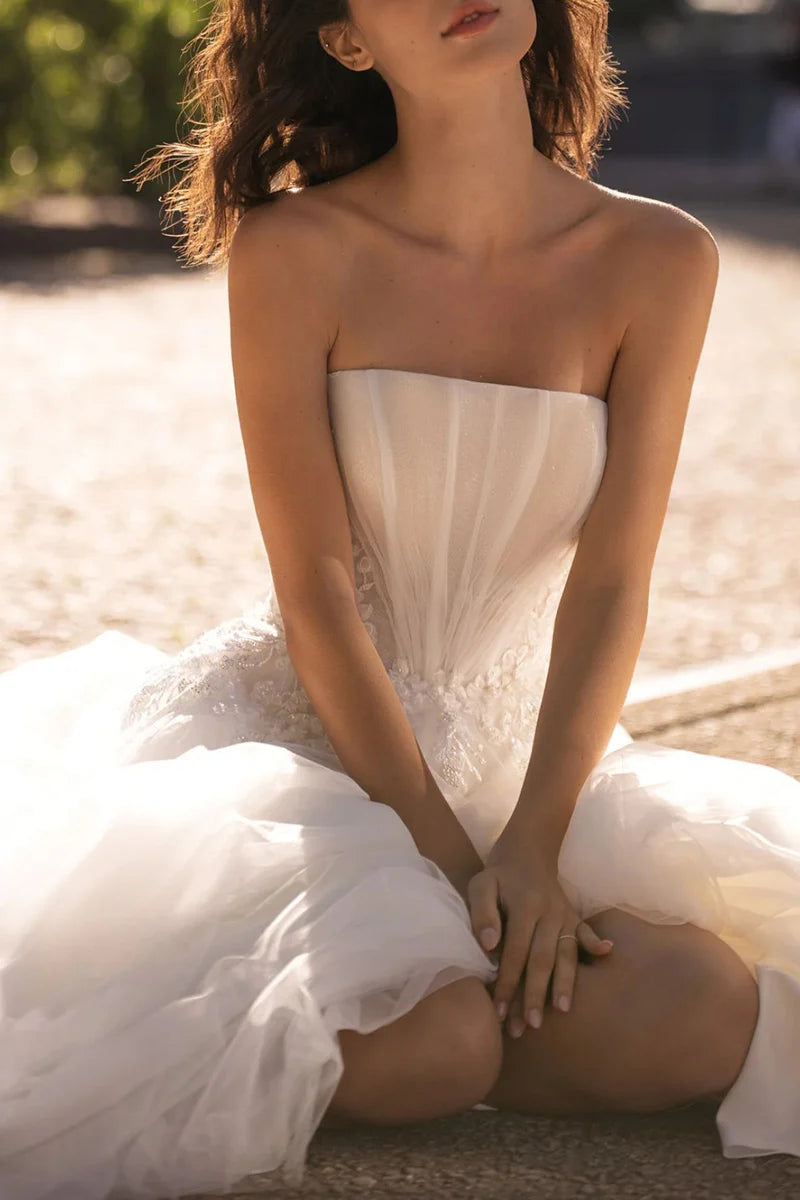 Close-up of lace appliques on an A-Line strapless wedding dress.