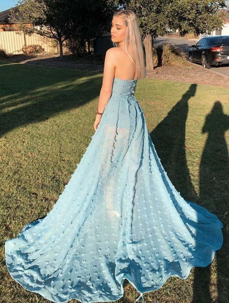 Side view of the elegant sky blue strapless gown with a flowing skirt.