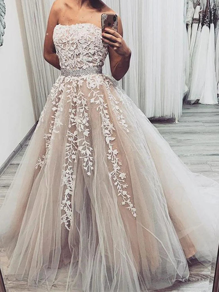 Woman wearing an elegant A-line strapless lace long wedding dress.