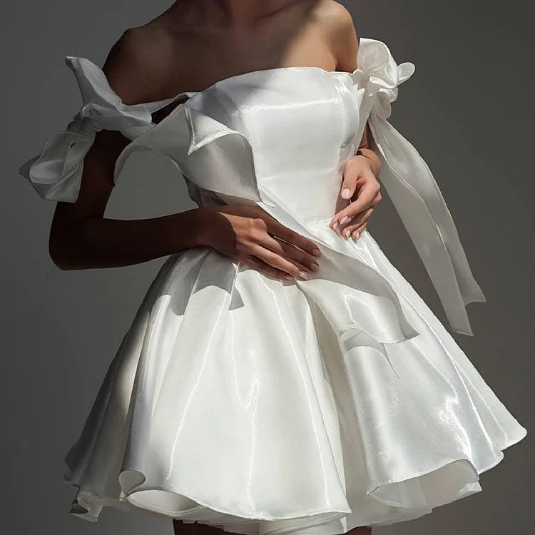 A-line strapless homecoming dress with lace-up back and bow detail.