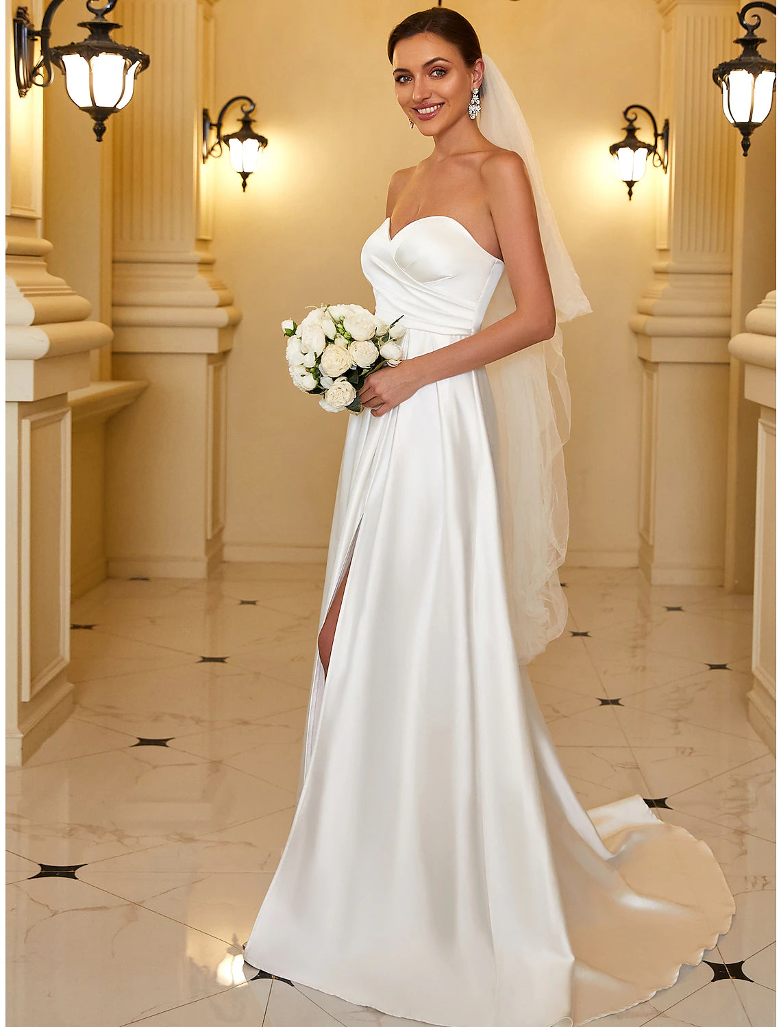 Side view of the A-line strapless satin gown.
