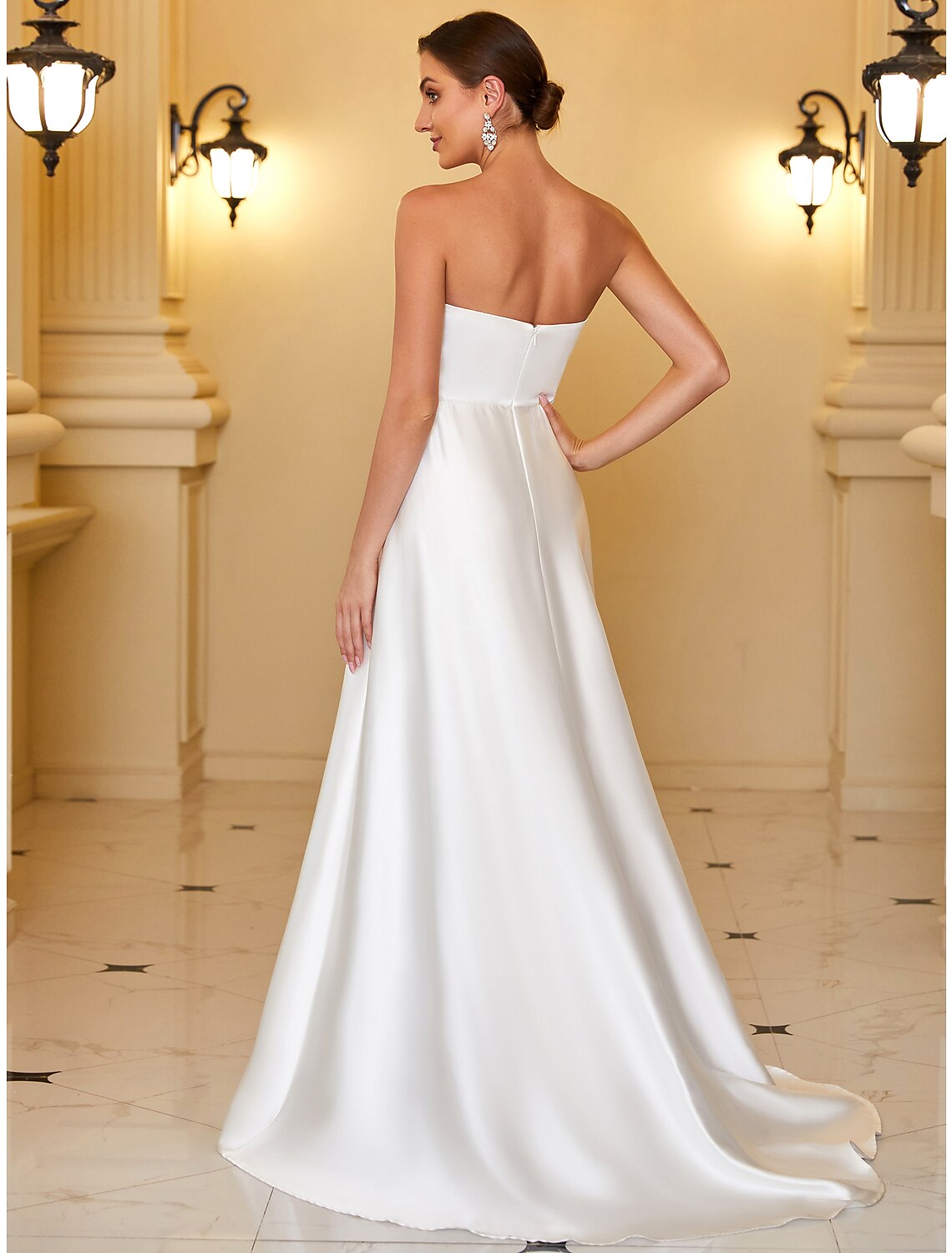 Back view of the A-line strapless satin gown with backless detail.