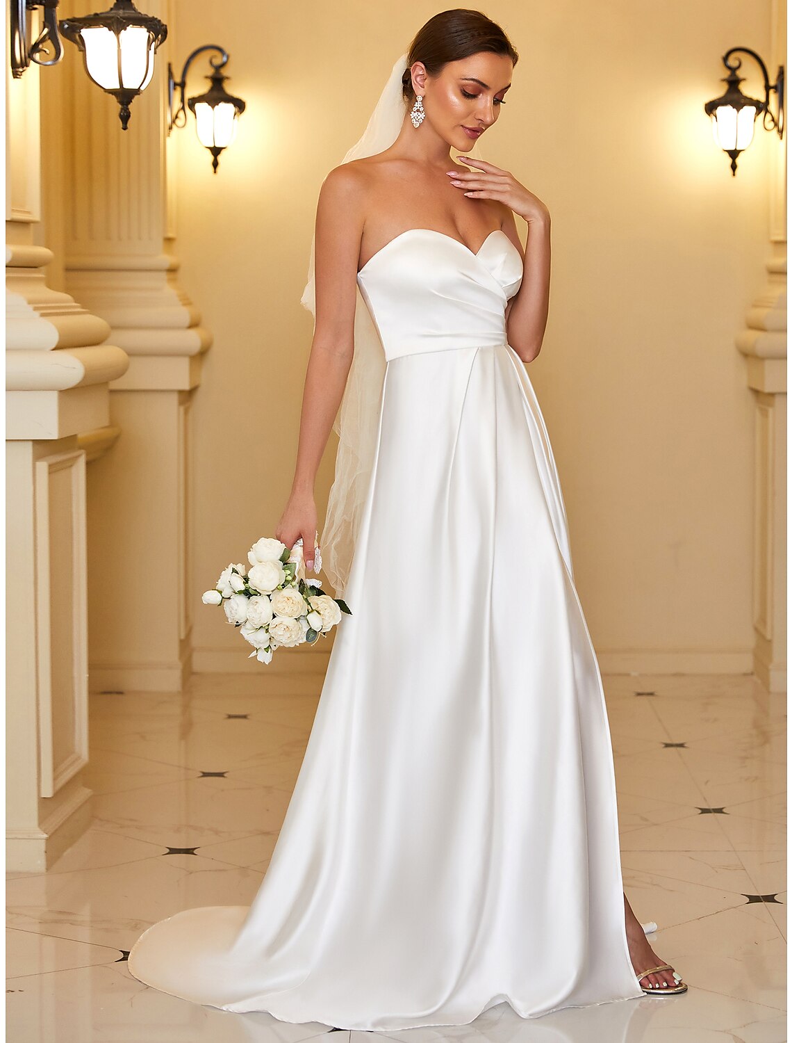 Front view of the minimalist floor-length satin dress.