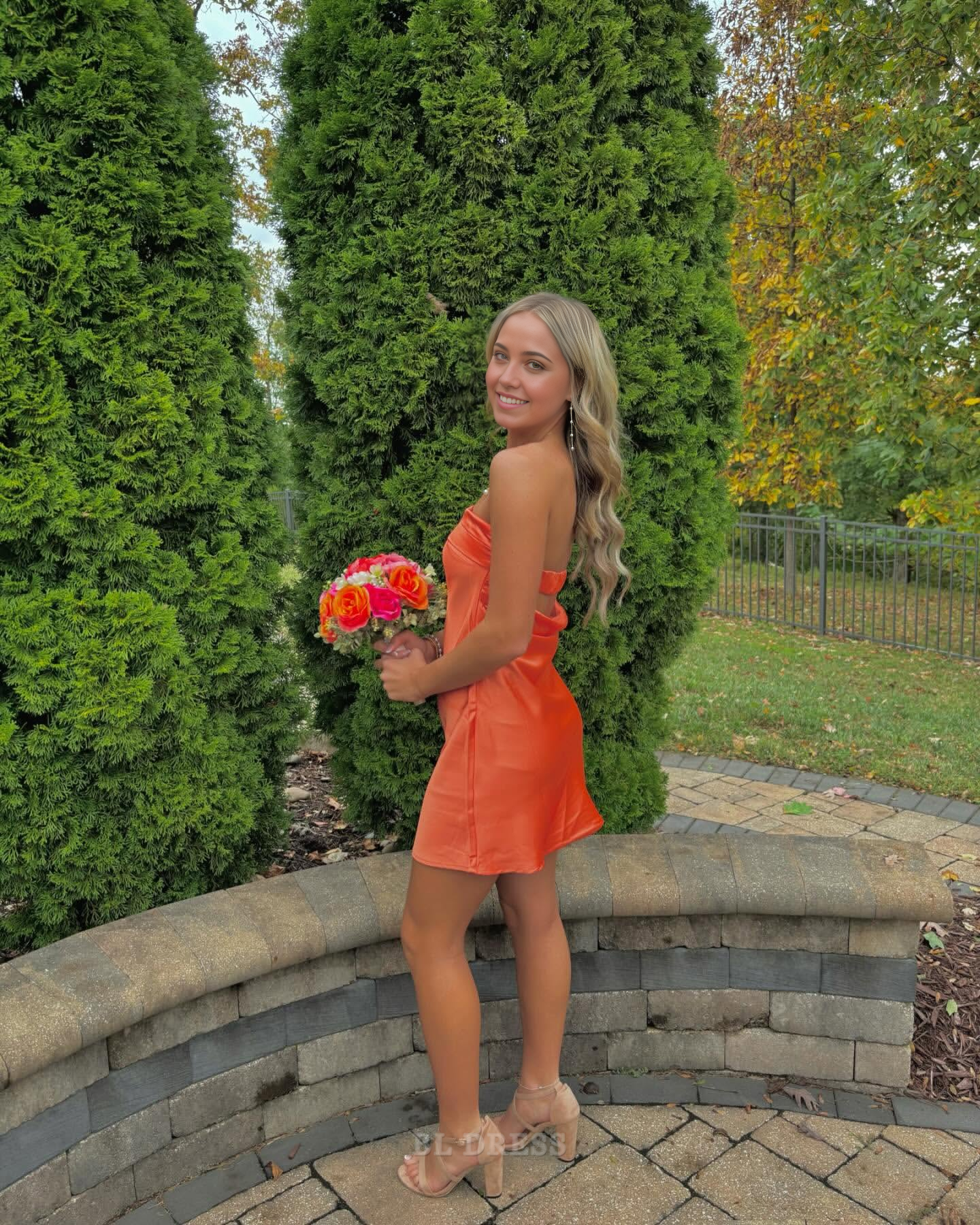 Orange satin short dress, back view.