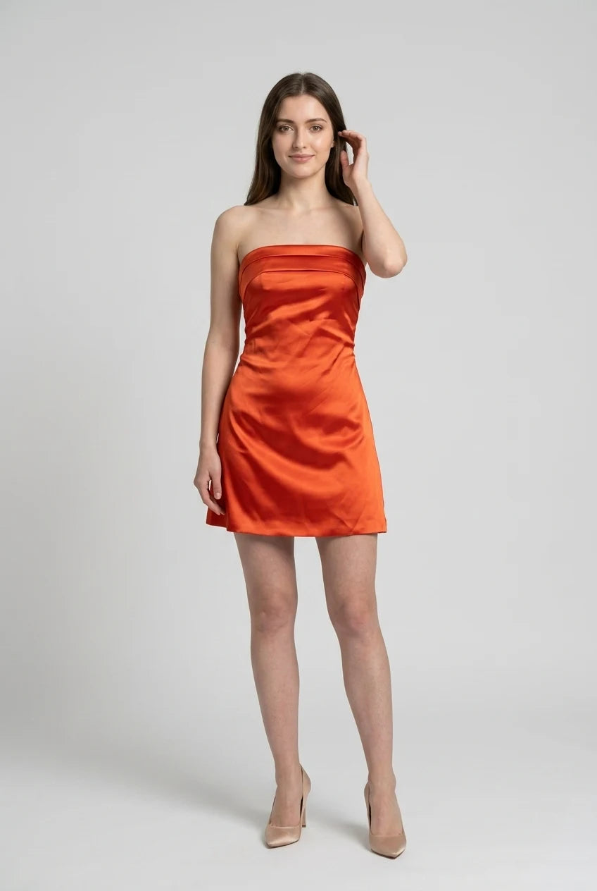 Model wearing an orange satin A-line strapless dress.