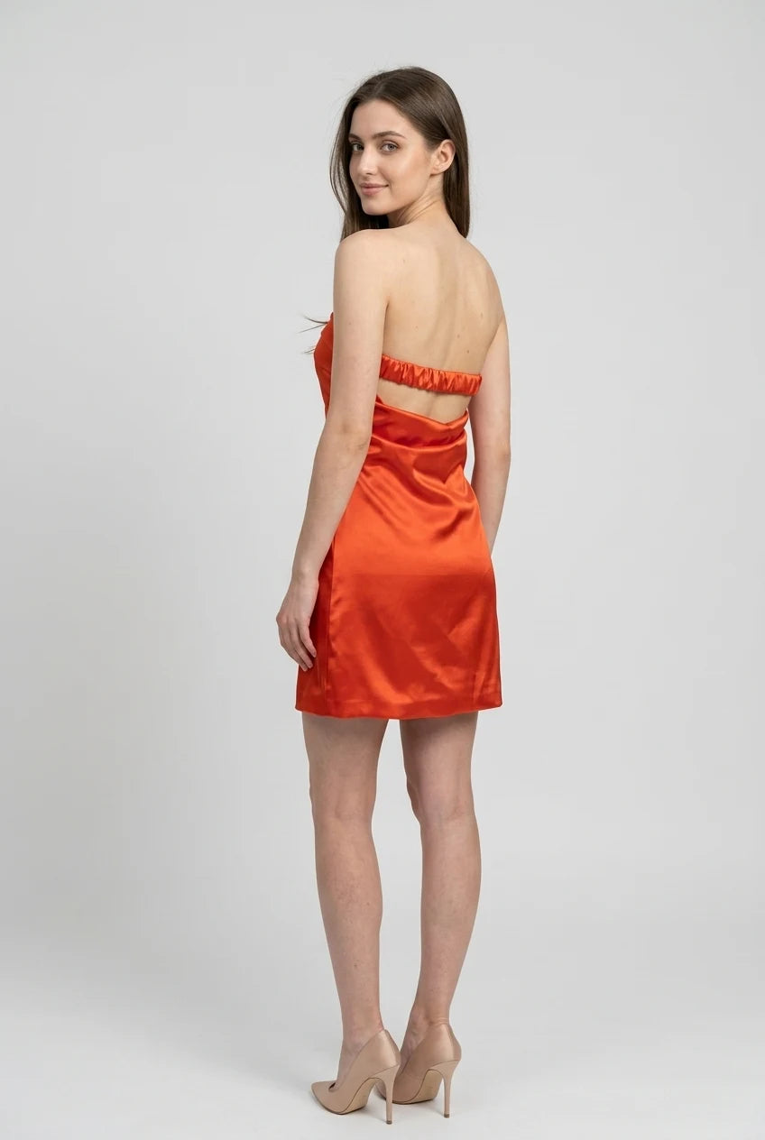 Close-up of the orange satin fabric and dress details.