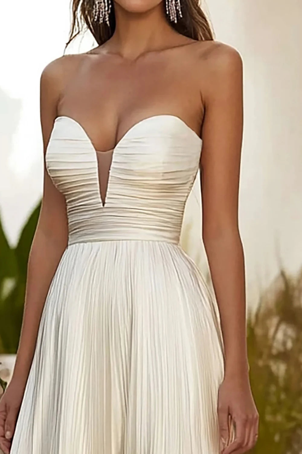 Model showcasing the flowy A-line strapless formal gown.