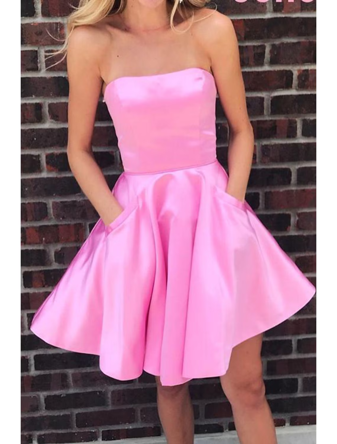 Side view of a short pleated satin homecoming dress.