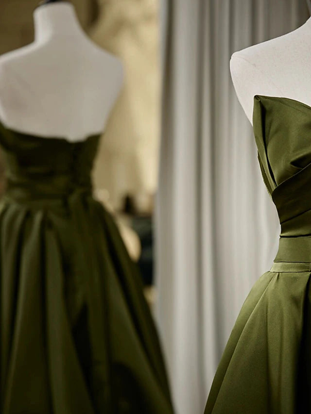 Detail of the strappy back on a black satin formal gown.