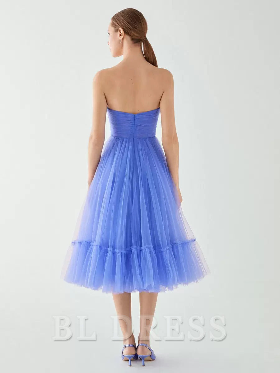 Back view of an A-line strapless pleated tulle dress.