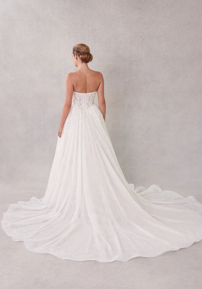 Close-up of the pleated bodice and tulle fabric of the wedding dress.