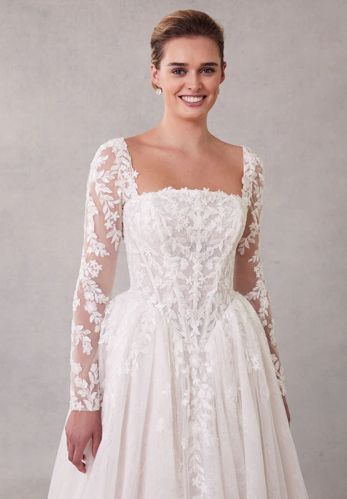 Model posing in the elegant white A-line wedding dress.