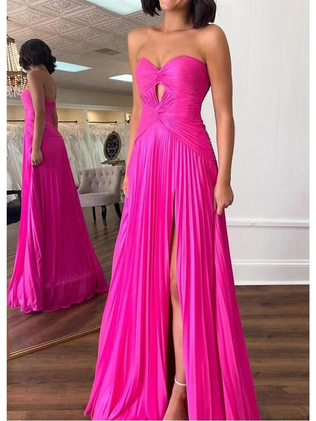 Full-length view of an elegant A-line strapless prom dress in a formal setting.