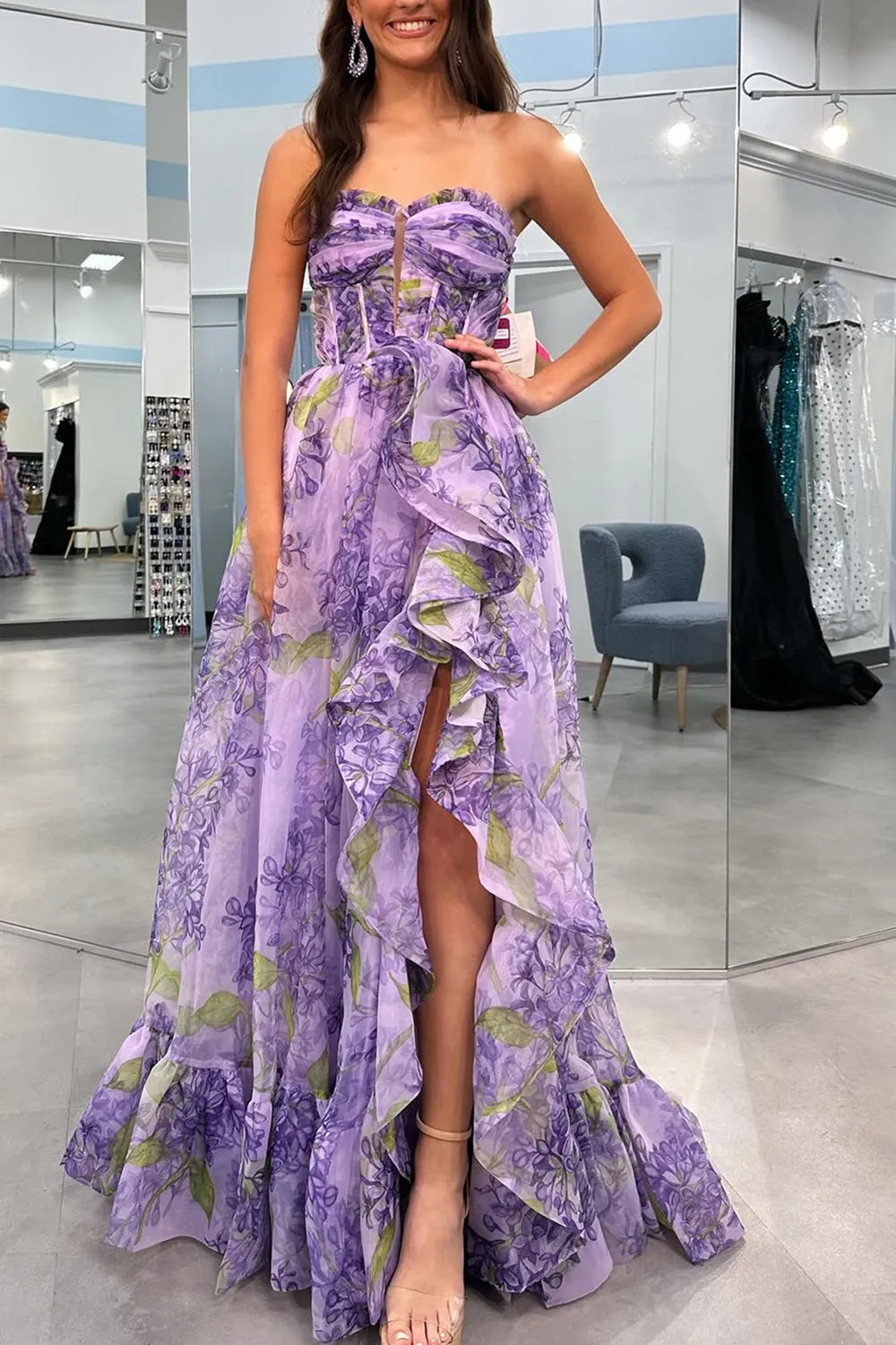 Woman modeling an A-line strapless prom dress with long detachable sleeves.