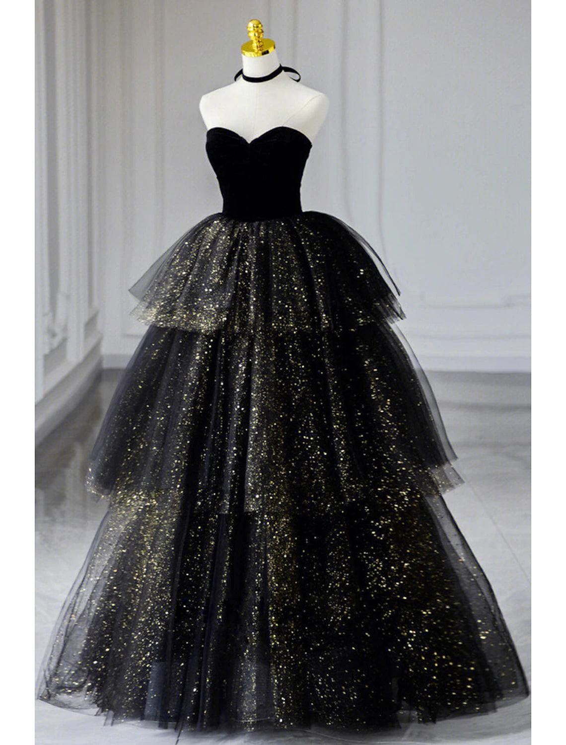Full view of the black A-line strapless prom dress with ruched sequin tulle.