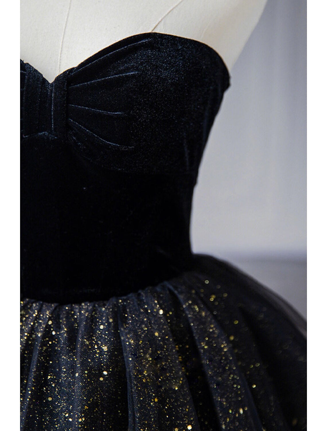 Another angle of the black A-line strapless prom dress, showcasing the flowing tulle skirt.