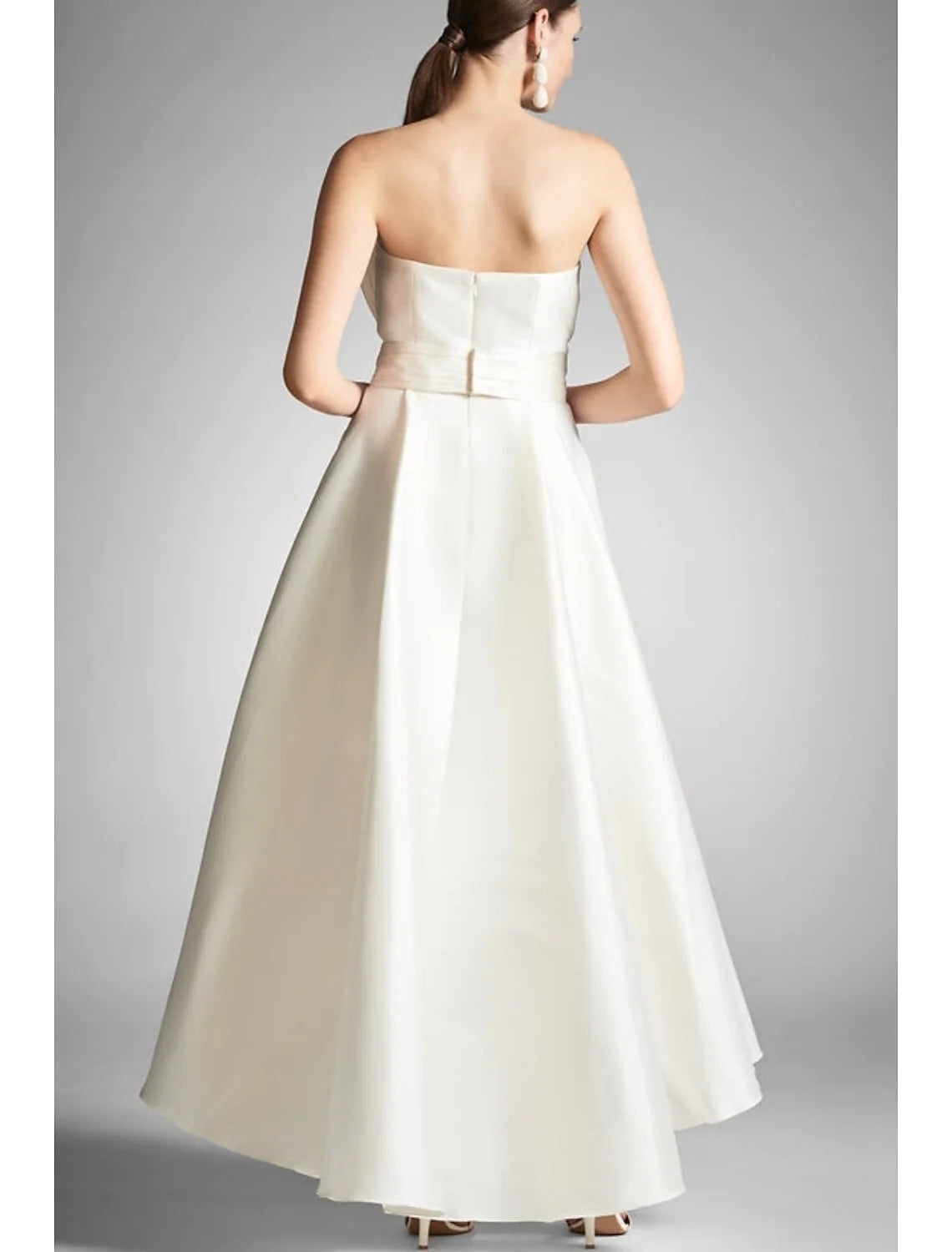 Back view of a formal A-line strapless ruched gown.