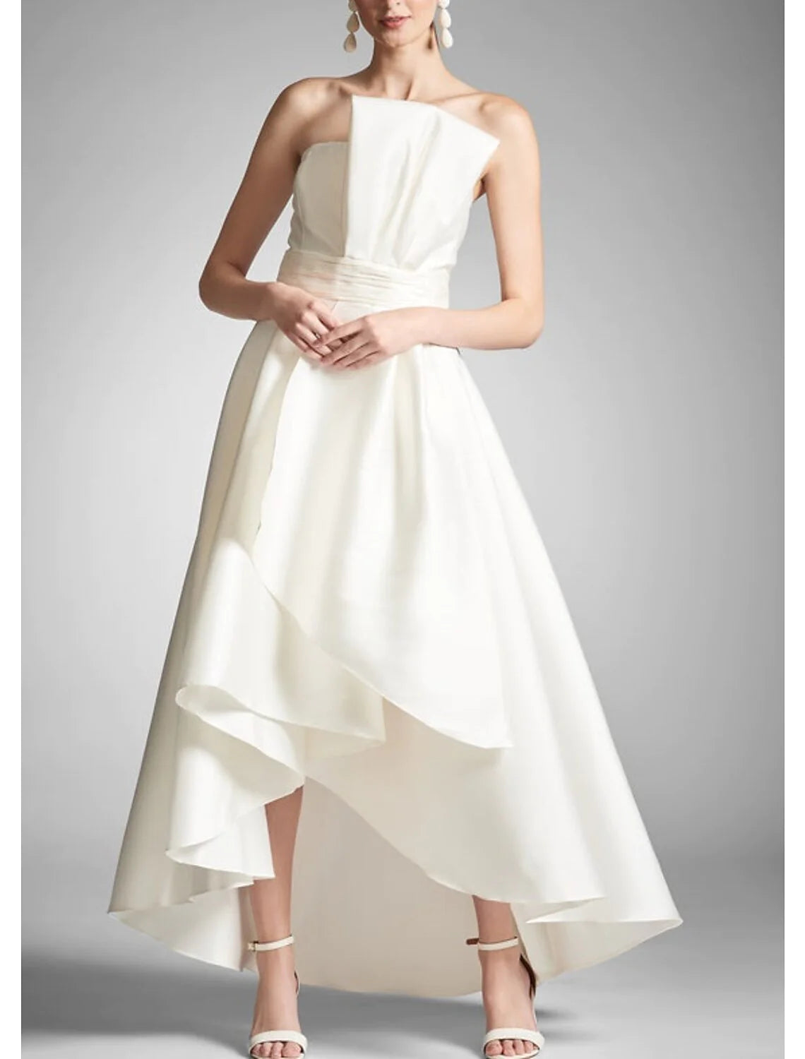 Side view of a sophisticated strapless taffeta dress.