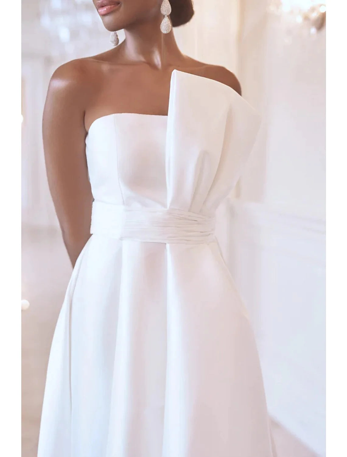Full length view of a strapless formal dress with asymmetrical ruching.