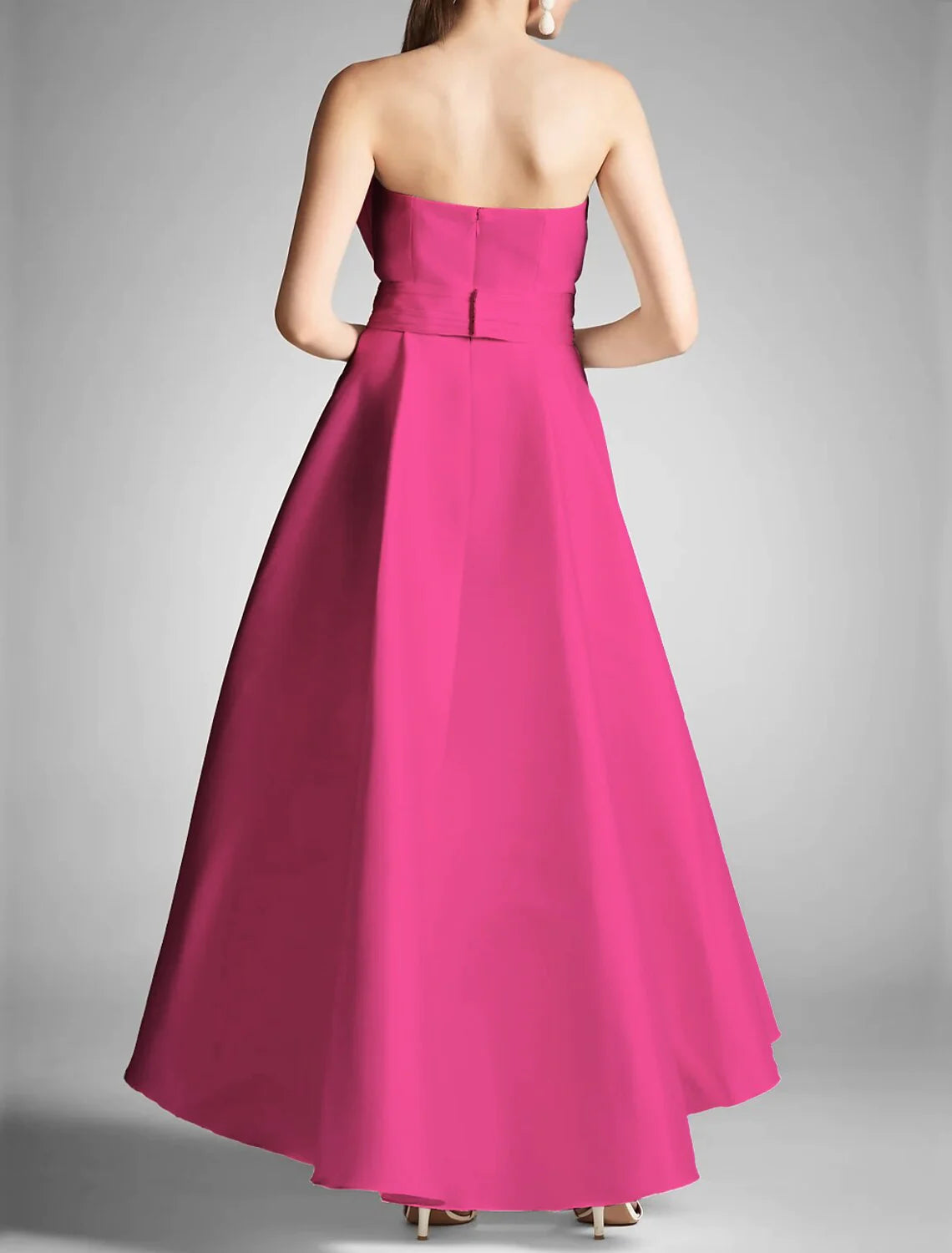 Model wearing an A-line strapless prom dress for a formal event.