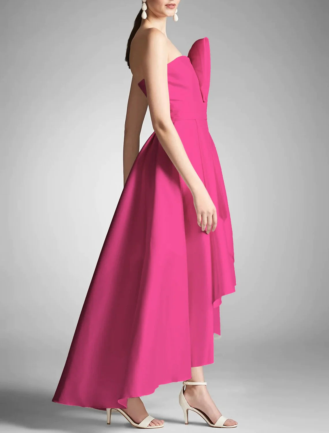 Flowing skirt and ruched bodice of a taffeta formal dress.