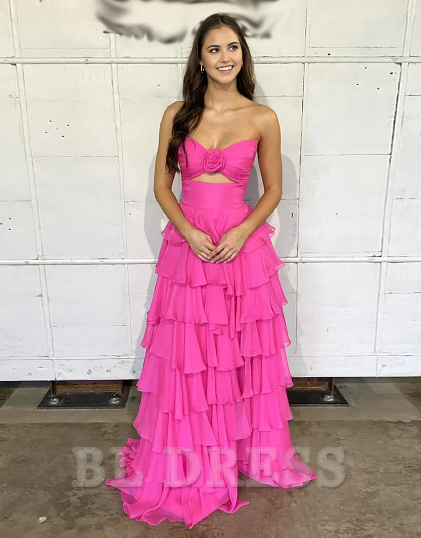 Side view of a woman wearing a black strapless formal dress with a ruffled bodice.
