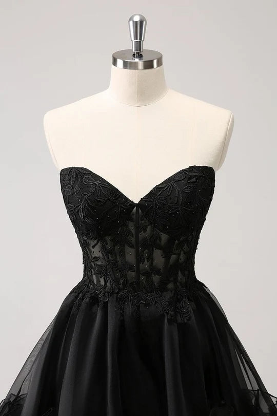 Woman posing in a chic A-line strapless ruffled corset short homecoming dress.