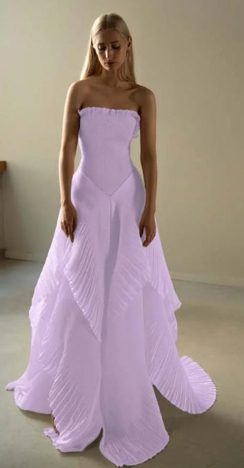 Side view of a woman wearing the strapless ruffled A-line prom dress.