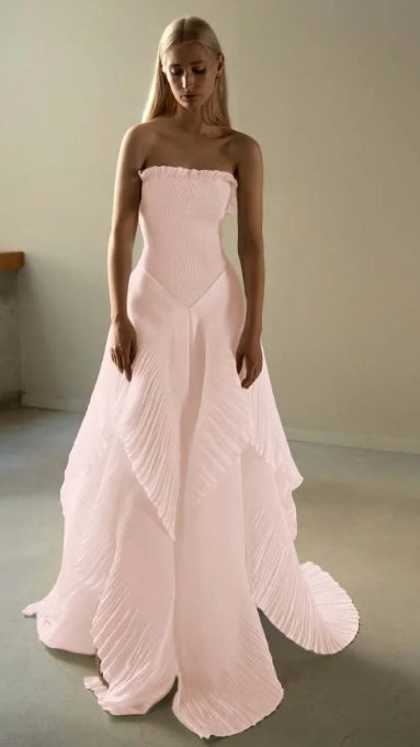 Close-up of the ruffled and pleated details on the strapless prom dress.