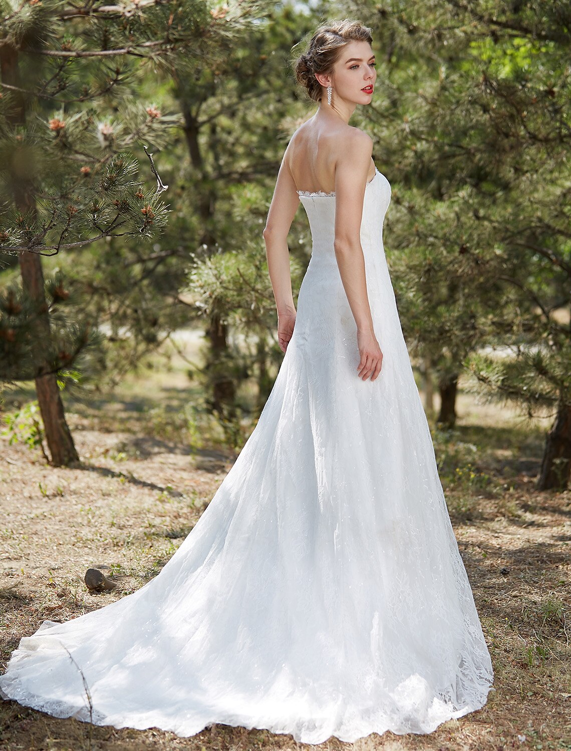Back view of an A-Line strapless bridal gown featuring a court train.