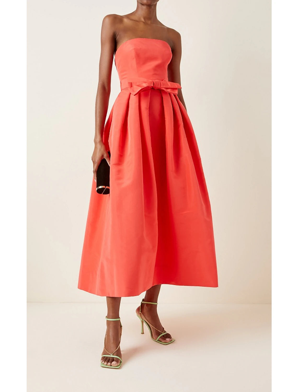 Side view of minimalist strapless satin dress.