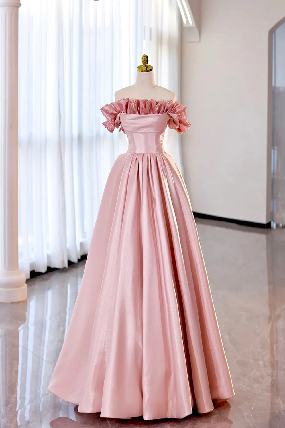Side profile of a woman wearing a strapless satin formal gown.