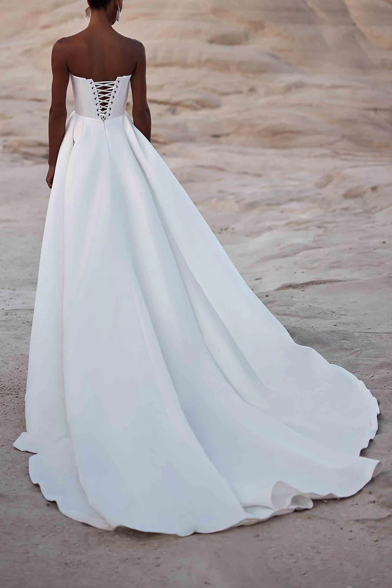 Close-up of the bodice and luxurious satin fabric of the strapless wedding gown.