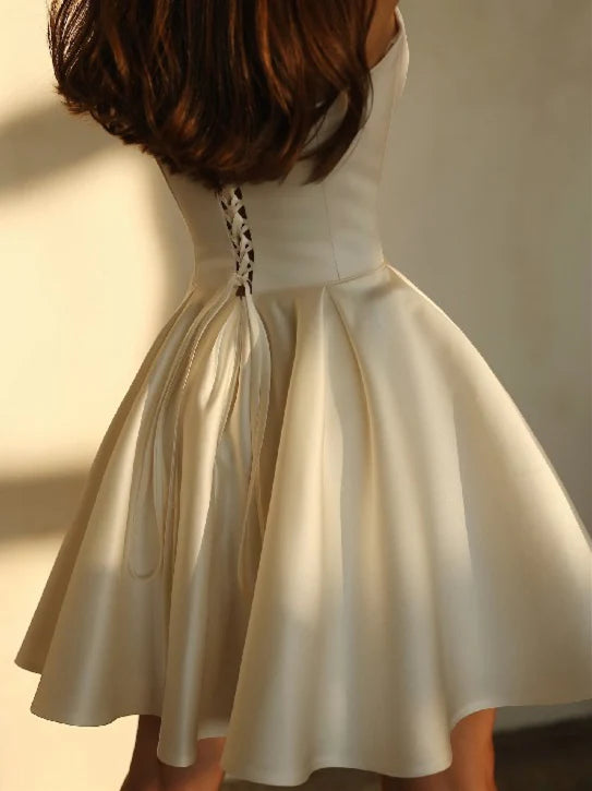 Back view of a model wearing a short satin A-Line wedding dress.