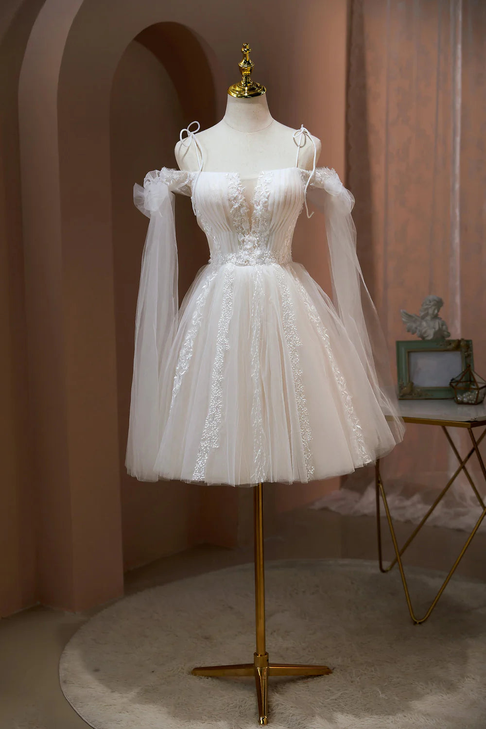 A-line short homecoming dress with appliques and strapless sweetheart neckline.