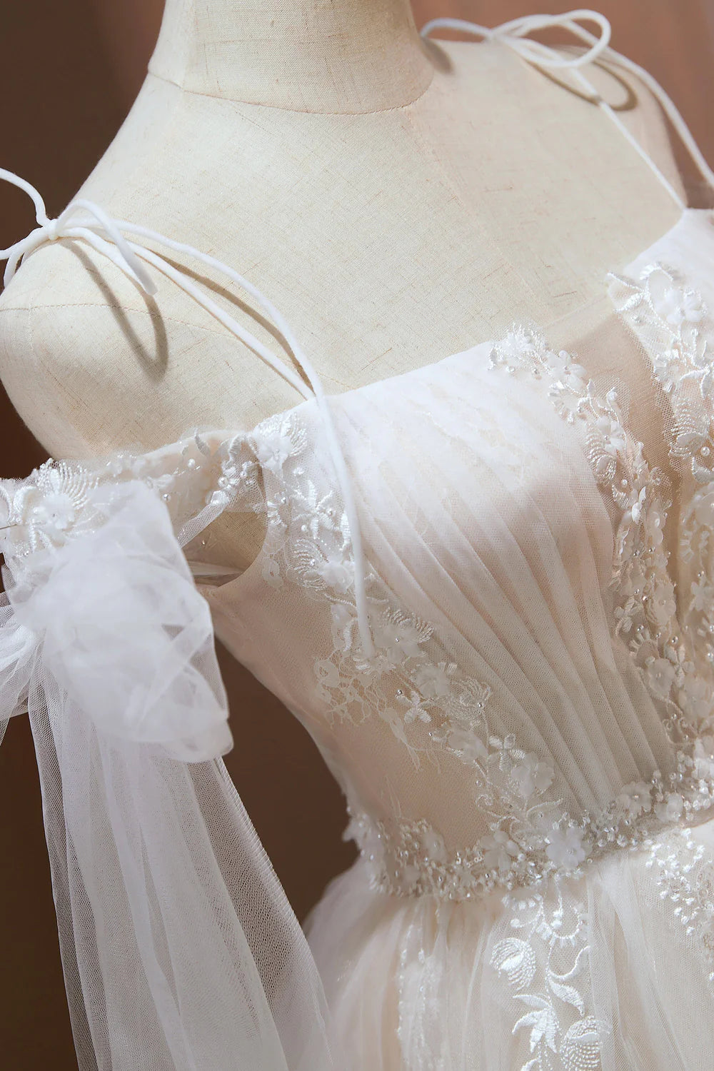 Close-up of delicate appliques on the tulle fabric of a short dress.