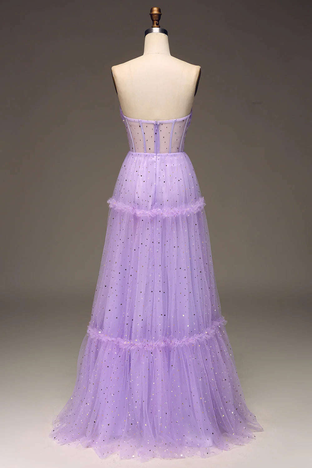 Side view of a model wearing the purple strapless A-line tulle gown.