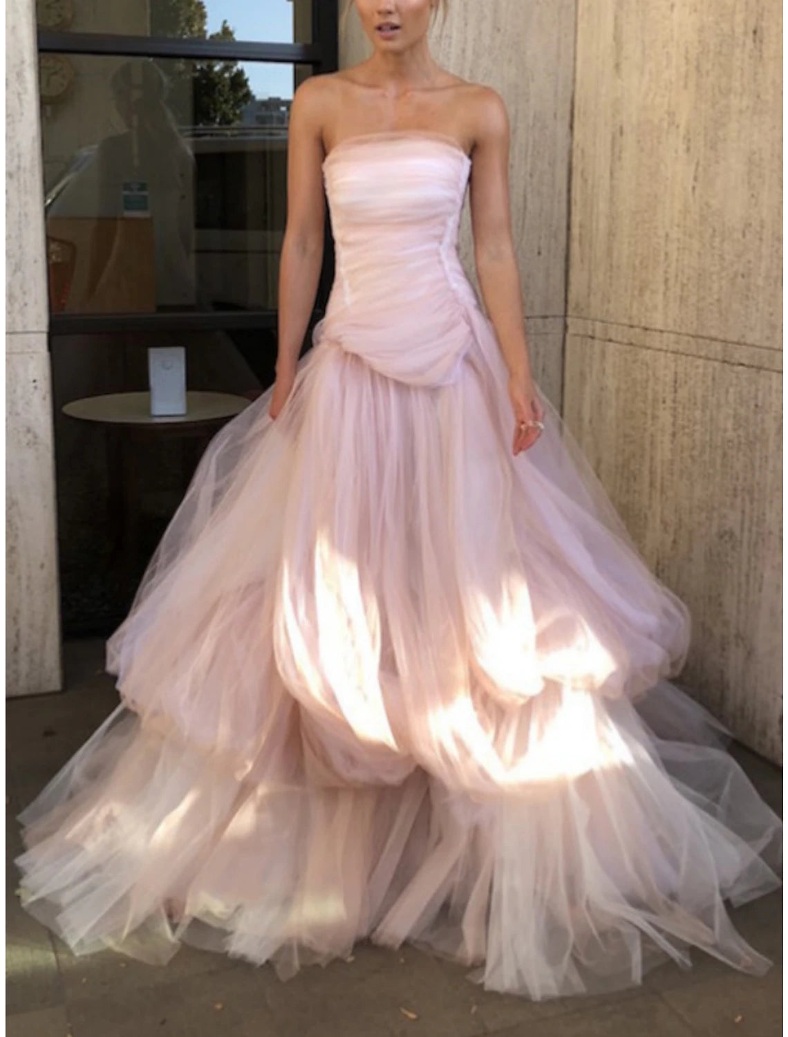 Full length view of the strapless sweetheart evening gown in a formal setting.