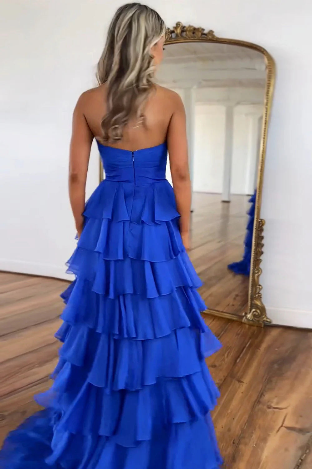 Royal blue A-line strapless tiered formal dress, side view.