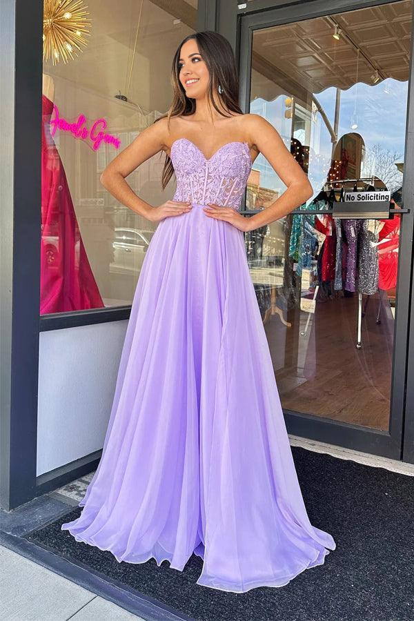 Back view of a model in a lilac A-line strapless tulle prom dress.