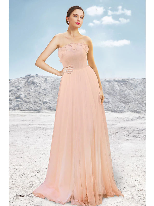 Elegant A-line strapless evening gown with pleated tulle and sweep train.