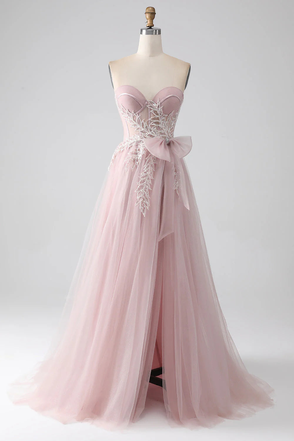 Elegant A-line strapless tulle prom dress in blush pink, front view.