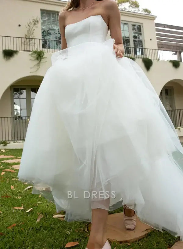 White A-line strapless tulle gown, detailed view.