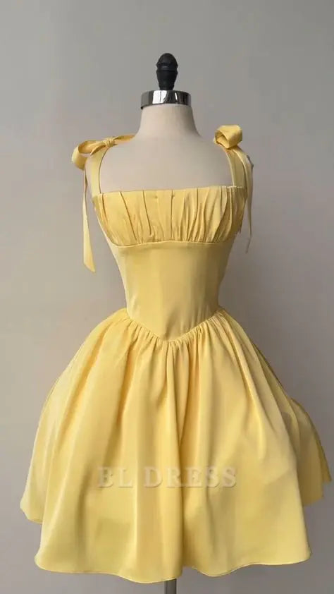 Elegant yellow A-line formal dress with delicate straps, suitable for prom or evening events.