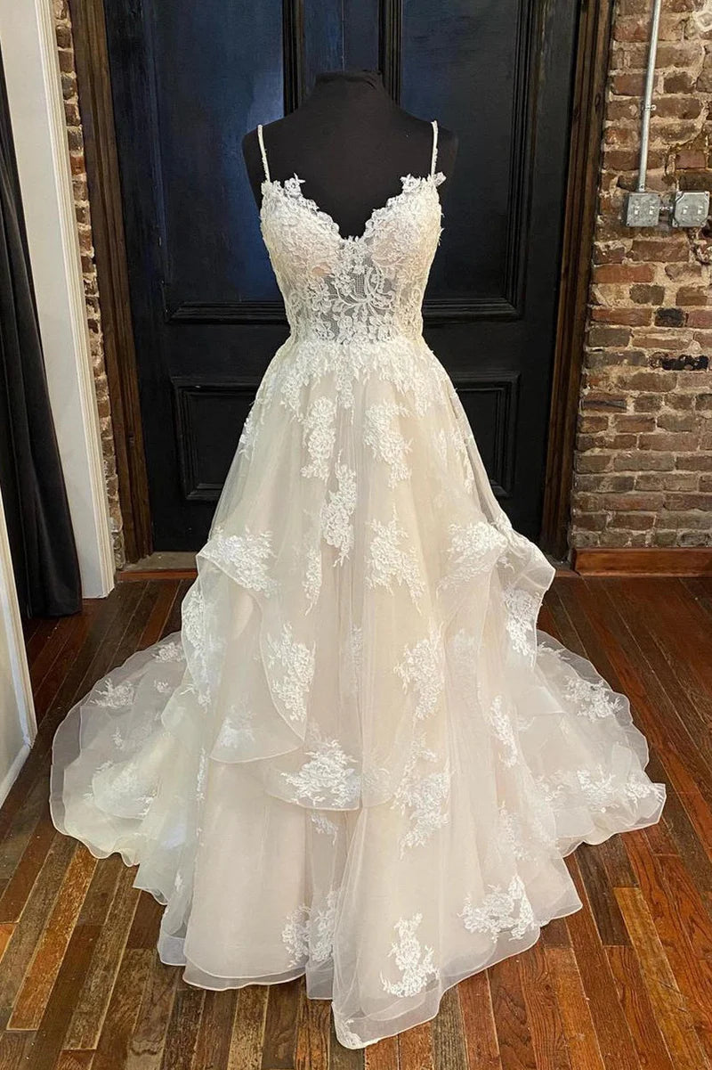 Elegant A-Line wedding dress with delicate straps and intricate appliques.