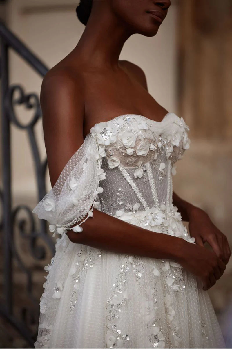Side profile of A-line wedding dress with sweetheart neckline and intricate 3D details.