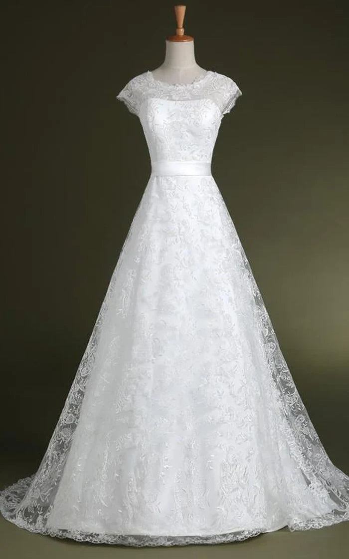 Elegant A-line wedding or formal gown with appliques, corset back, and full tulle skirt.