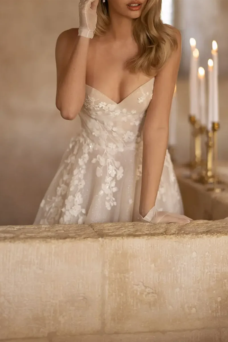 Full view of the A-line wedding dress with a court train and detailed appliques.