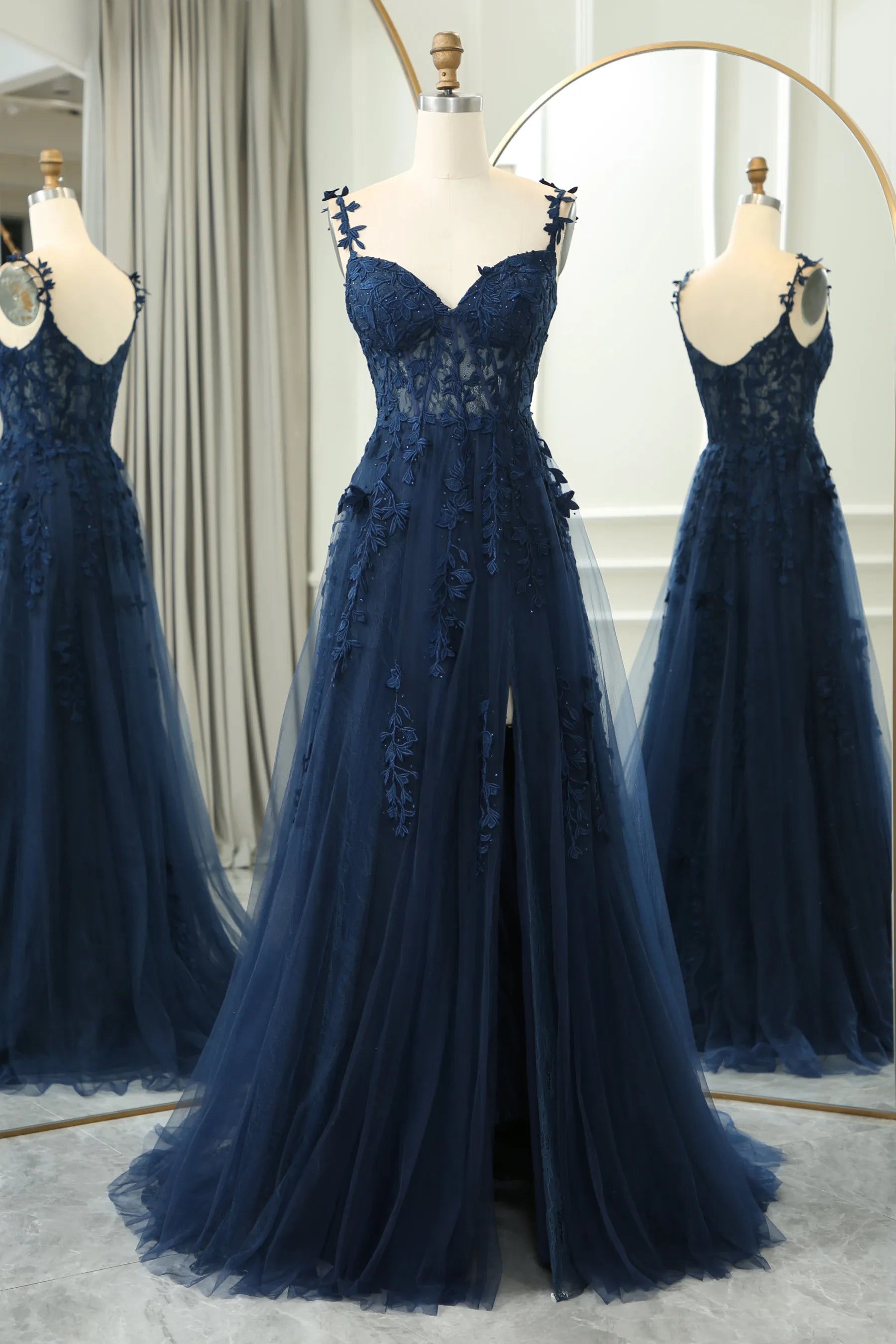 Front view of an elegant light blue A-line prom dress with spaghetti straps and appliques.